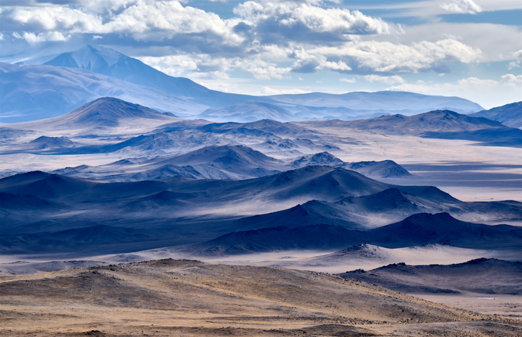Snow-capped peaks above a river valley on an Altai Mountains tour in Russia and Mongolia