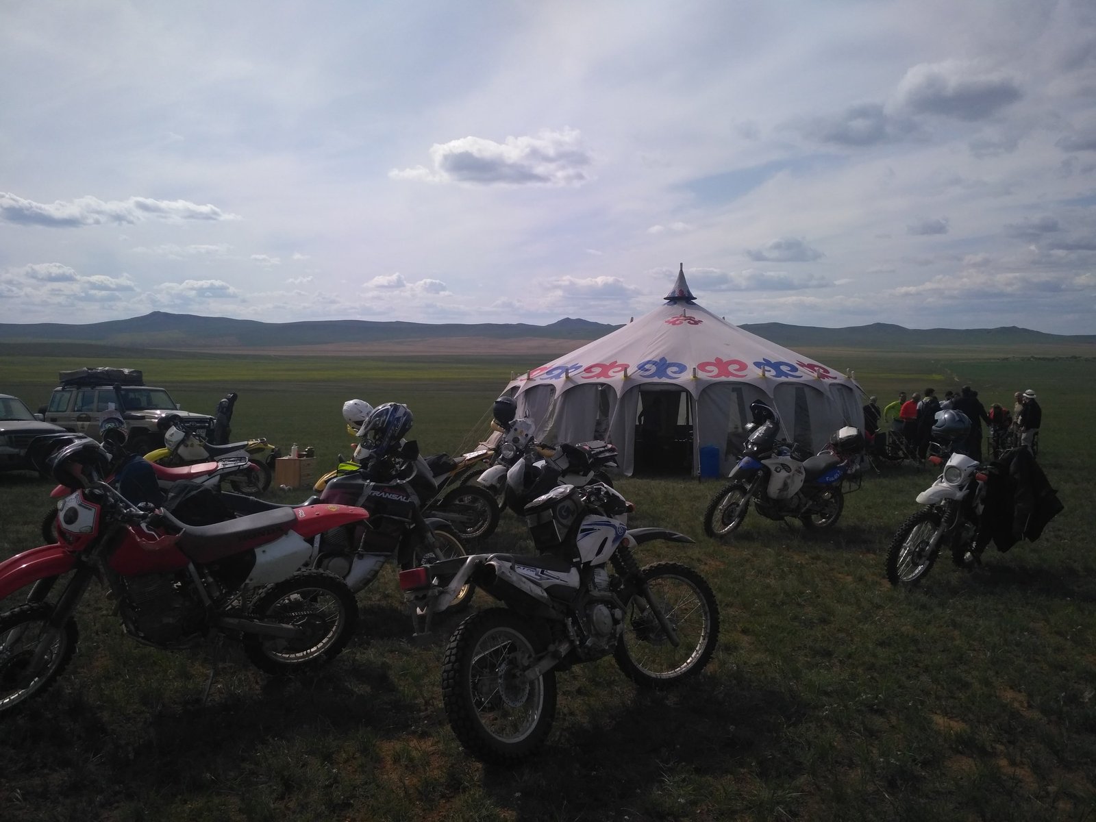 Lone rider crossing a dried cracked riverbed on the steppe