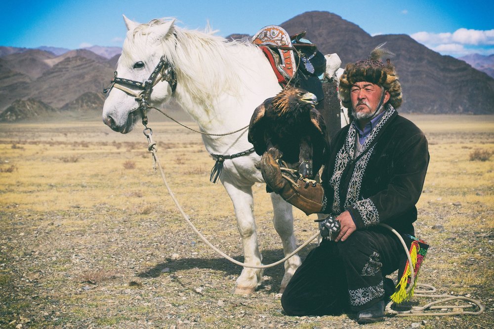 Rider on horseback crossing the Altai Mountains on a horse trek in Mongolia