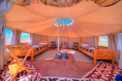 Interior of a mobile ger with twin beds and traditional painted furniture